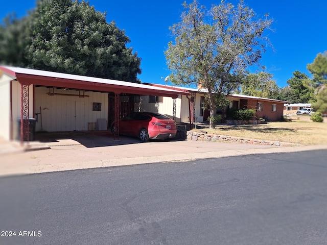 view of front of property featuring an attached carport and driveway