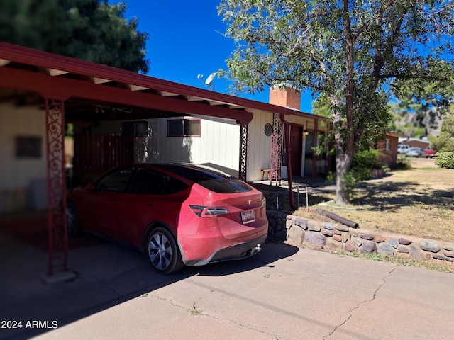 exterior space with a chimney and an attached carport