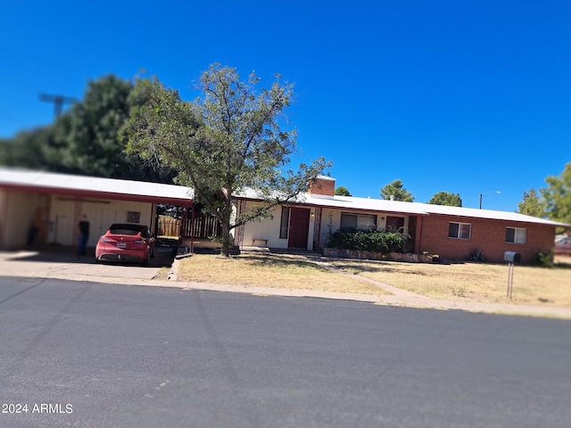 ranch-style house with a carport