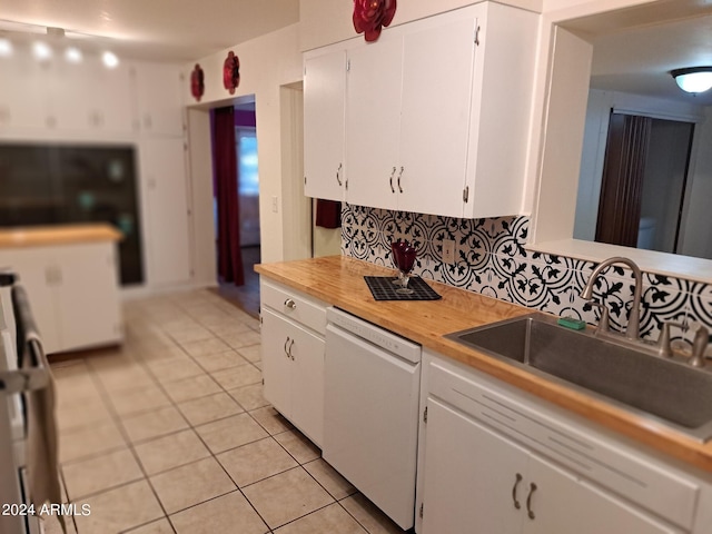 kitchen featuring white cabinetry, white dishwasher, a sink, and light tile patterned flooring