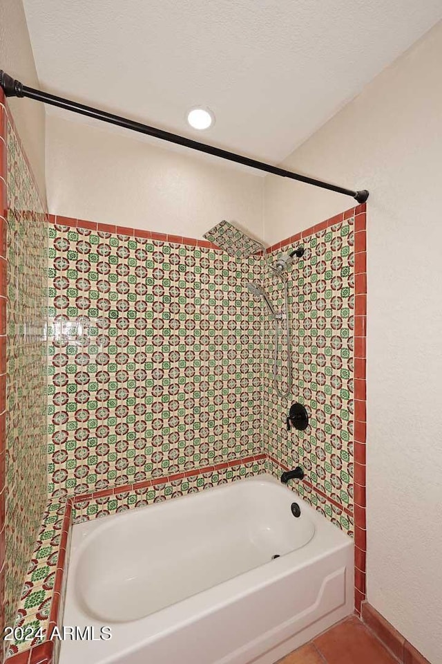 full bath featuring tile patterned flooring, shower / bath combination, and a textured ceiling