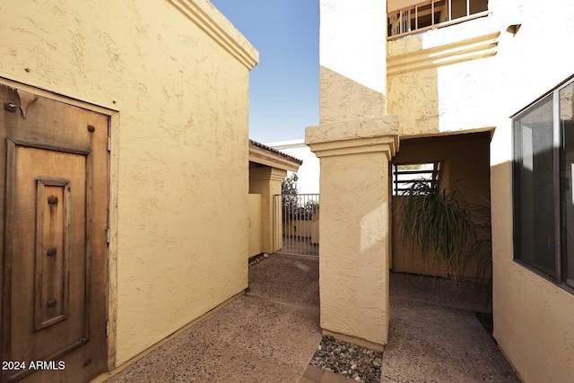 view of home's exterior with a gate and stucco siding