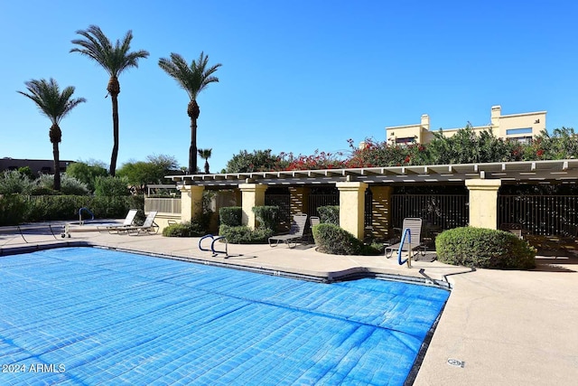 pool featuring a patio area, fence, and a pergola