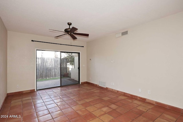 spare room with ceiling fan, visible vents, and baseboards