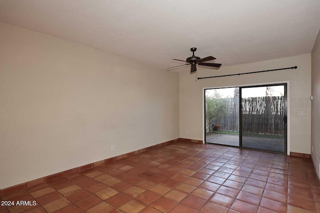 tiled spare room with ceiling fan, a textured ceiling, and baseboards