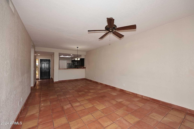 interior space featuring ceiling fan and baseboards