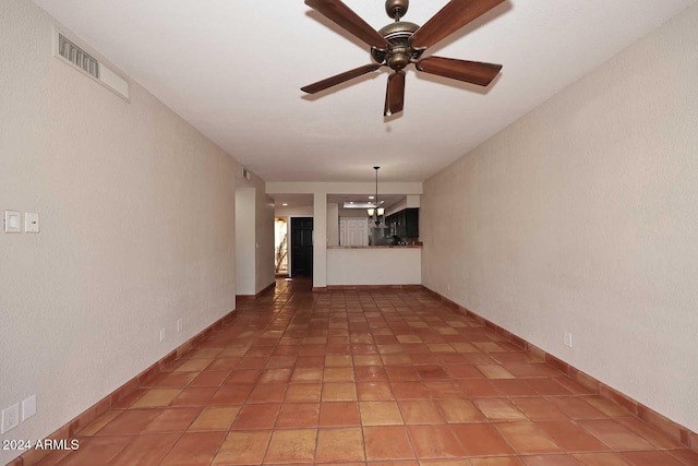 unfurnished living room with a ceiling fan, visible vents, baseboards, and tile patterned floors