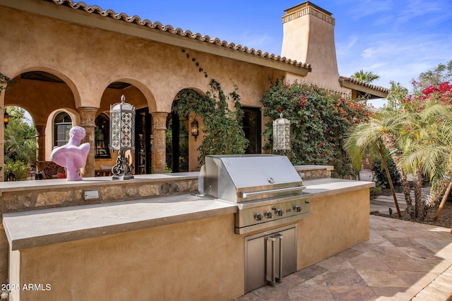 view of patio / terrace featuring exterior kitchen and area for grilling