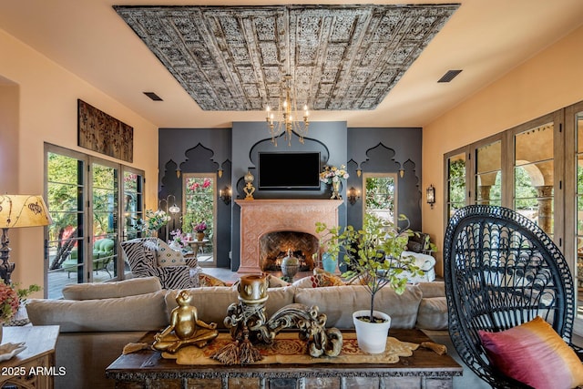 living room featuring plenty of natural light and a notable chandelier