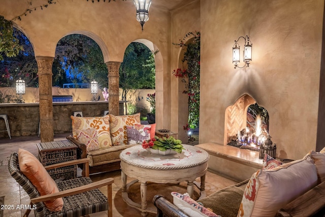 view of patio with an outdoor living space with a fireplace