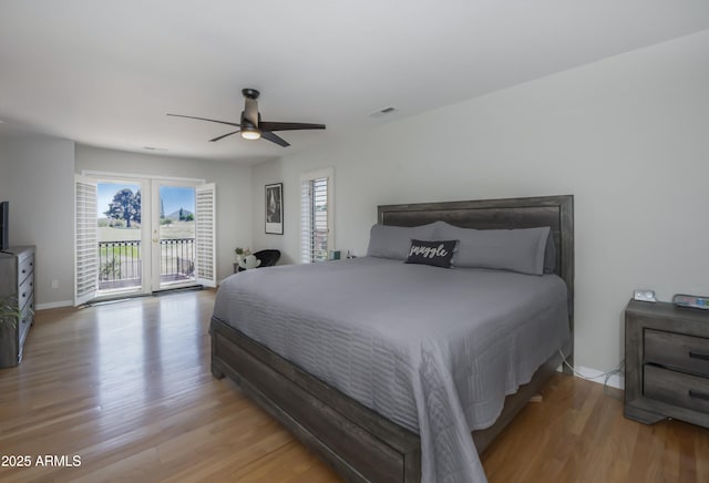 bedroom featuring access to outside, ceiling fan, light wood-style flooring, baseboards, and visible vents