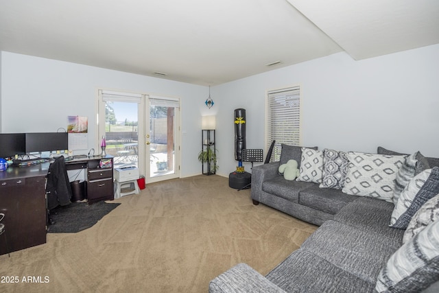 living room with visible vents and light carpet