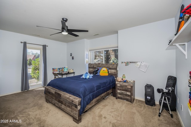 carpeted bedroom with multiple windows, ceiling fan, and visible vents