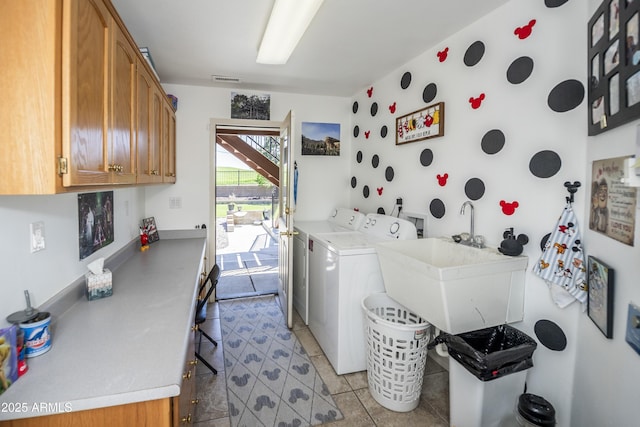 laundry area with washer and dryer, light tile patterned flooring, cabinet space, a sink, and visible vents