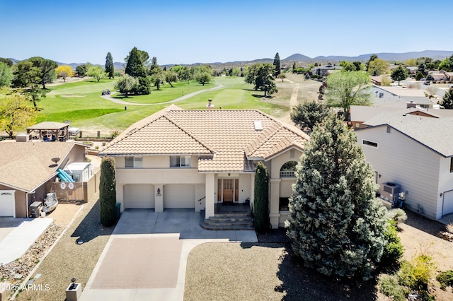 birds eye view of property with a mountain view and golf course view