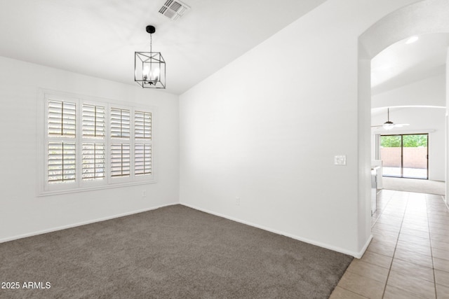 carpeted empty room with arched walkways, baseboards, visible vents, and ceiling fan with notable chandelier