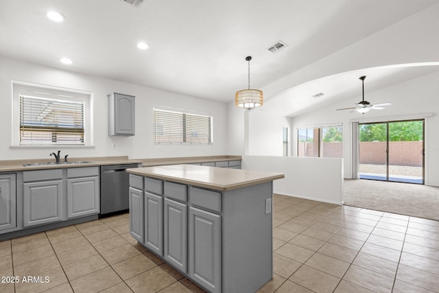 kitchen with a sink, a center island, gray cabinets, and dishwasher