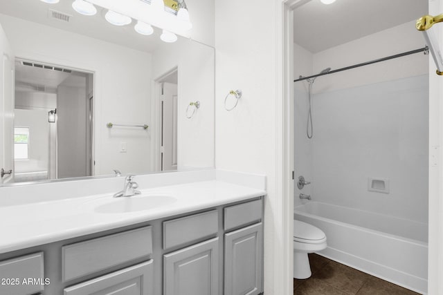full bath with shower / tub combination, vanity, toilet, tile patterned floors, and visible vents