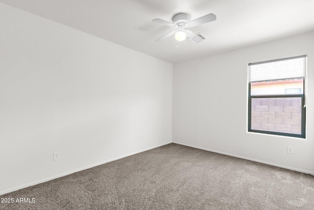 empty room featuring carpet floors, ceiling fan, and baseboards