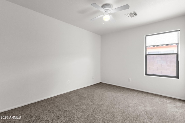 empty room with visible vents, carpet flooring, baseboards, and ceiling fan