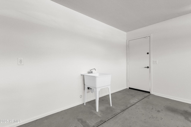 washroom with baseboards