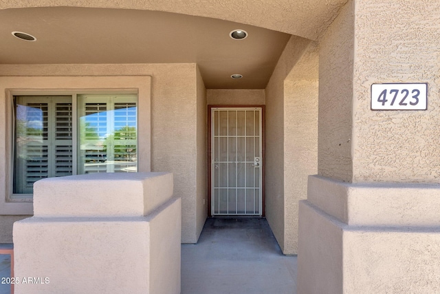 view of exterior entry with stucco siding