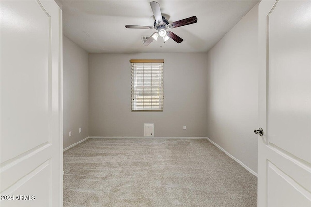 carpeted empty room featuring ceiling fan