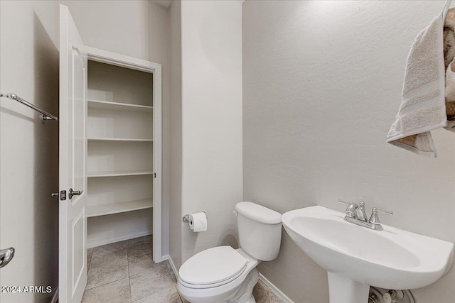 bathroom with tile patterned floors, sink, and toilet