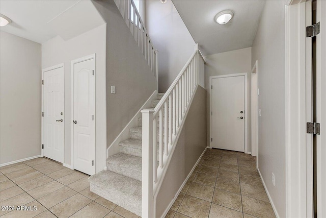 staircase featuring tile patterned floors