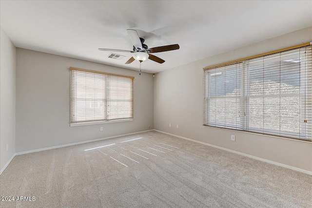 unfurnished room with ceiling fan and light colored carpet