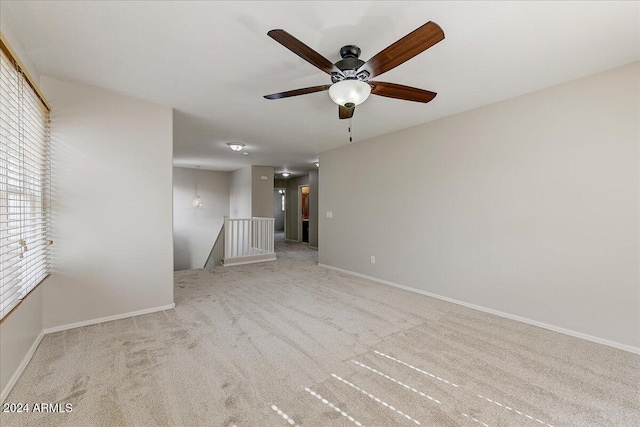 unfurnished room with light carpet and ceiling fan