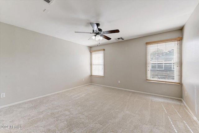 carpeted empty room featuring ceiling fan