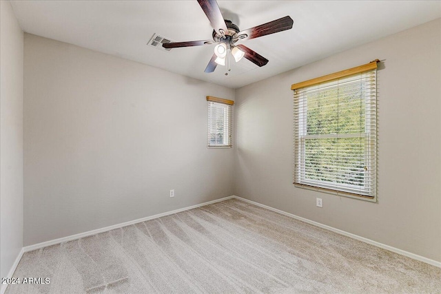 carpeted spare room with ceiling fan