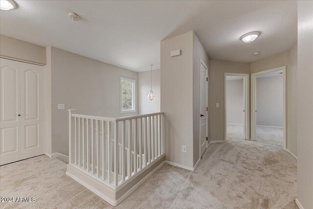 hallway featuring light carpet