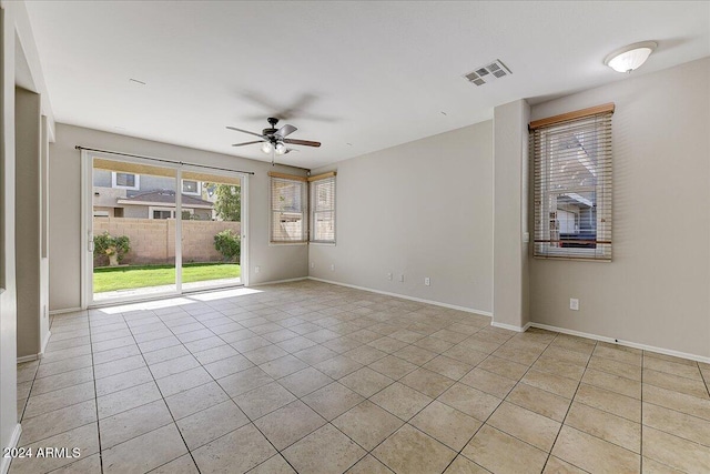 empty room featuring light tile patterned floors and ceiling fan