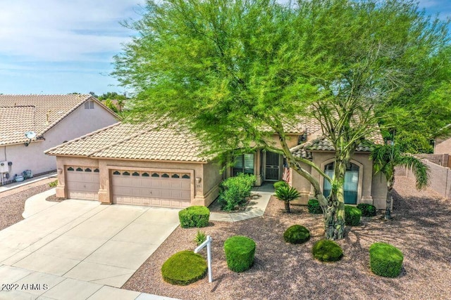 694 W Beechnut Dr, Chandler, AZ 85248 - view of front of home with stucco siding, a garage, concrete driveway, and a tiled roof