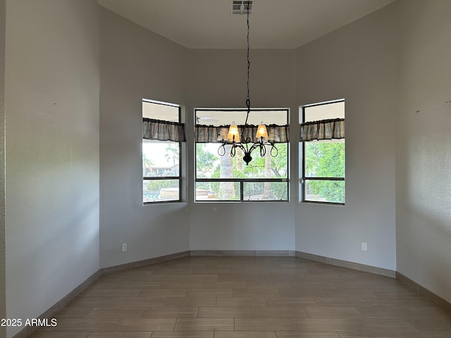 694 W Beechnut Dr, Chandler, AZ 85248 - empty room with a chandelier and plenty of natural light