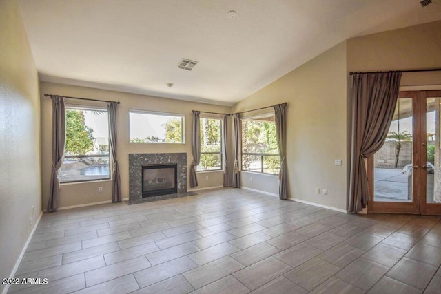 694 W Beechnut Dr, Chandler, AZ 85248 - unfurnished living room with plenty of natural light, vaulted ceiling, french doors, and a premium fireplace