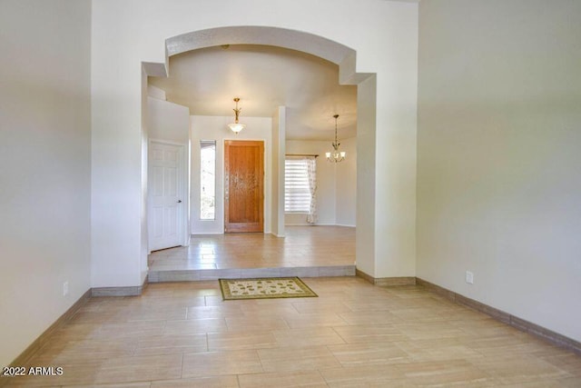694 W Beechnut Dr, Chandler, AZ 85248 - entryway with arched walkways, wood finished floors, and a chandelier
