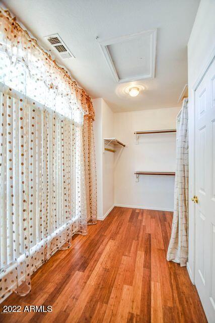 694 W Beechnut Dr, Chandler, AZ 85248 - walk in closet with attic access and wood finished floors