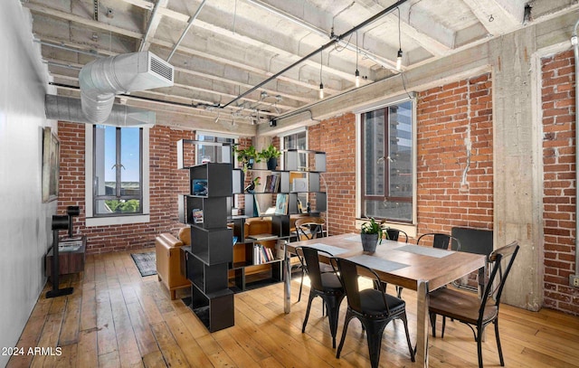 interior space featuring wood-type flooring and brick wall