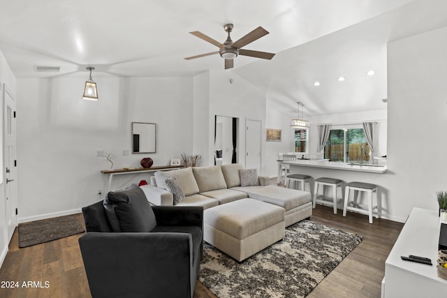 living room with ceiling fan, lofted ceiling, and dark hardwood / wood-style flooring