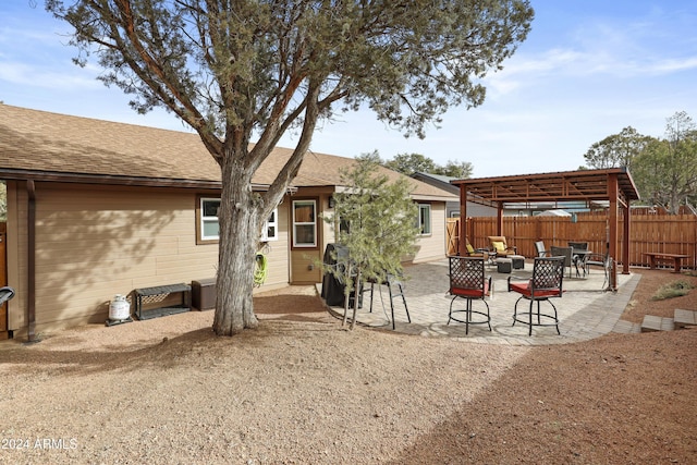 back of property featuring a pergola and a patio area