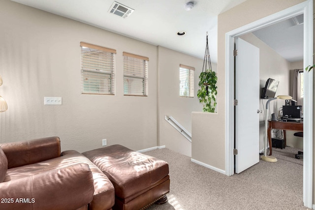 sitting room featuring baseboards, visible vents, carpet flooring, and an upstairs landing