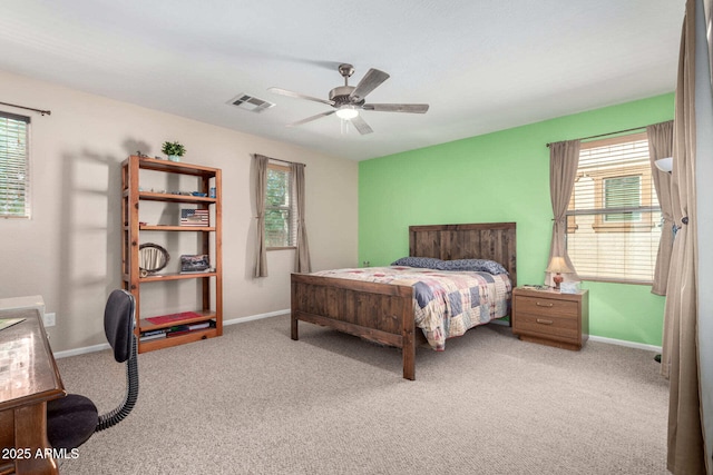 carpeted bedroom with baseboards, multiple windows, and visible vents