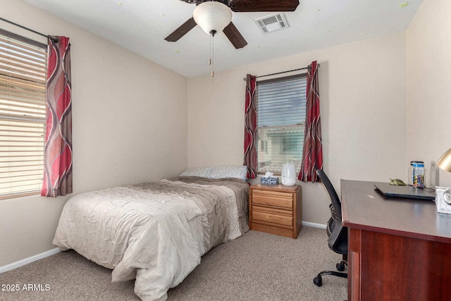 bedroom with a ceiling fan, light carpet, visible vents, and baseboards