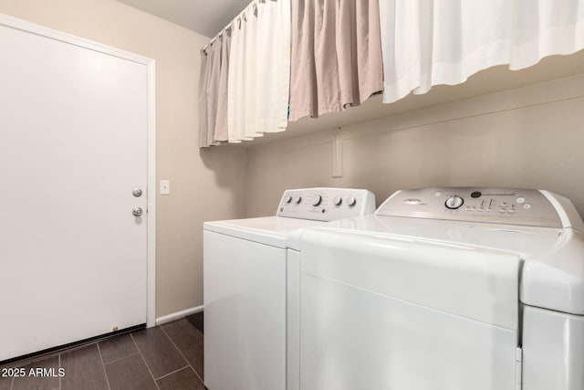 washroom with wood finish floors, laundry area, and washer and clothes dryer