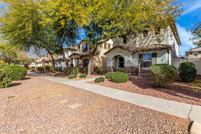 view of front of property with a residential view, a tile roof, and stucco siding