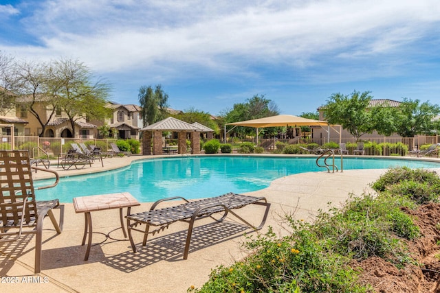 pool with a patio, a gazebo, and fence