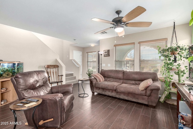 living area with a ceiling fan, stairway, visible vents, and wood tiled floor